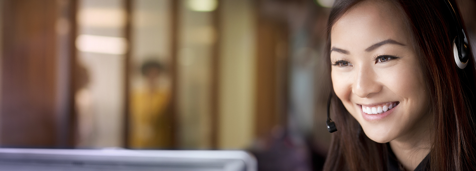 Smiling quitline counselor wearing a headset